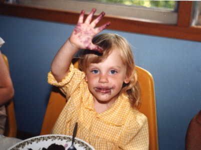 Young Anna with beets or berries on face and hands