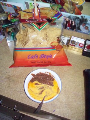 Tortilla chips and nacho cheese with beans