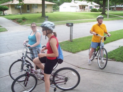 Mom and Anna and Joanna on bicycles