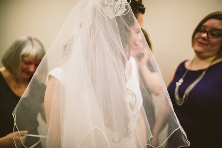 My mother helping lace up my dress