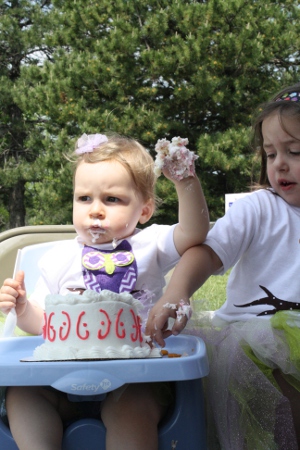 H enjoys her first birthday cake