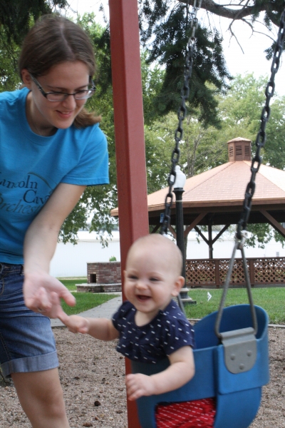 Aunt Joanna helps Tirzah Mae get acquainted with the swing