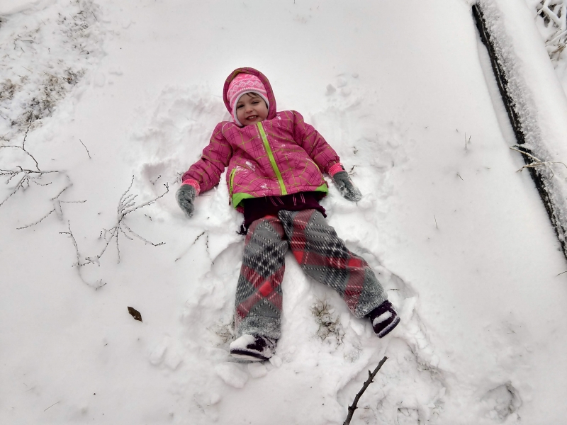 Tirzah Mae making a snow angel