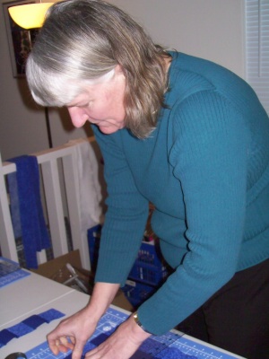 Mom cutting out a quilt
